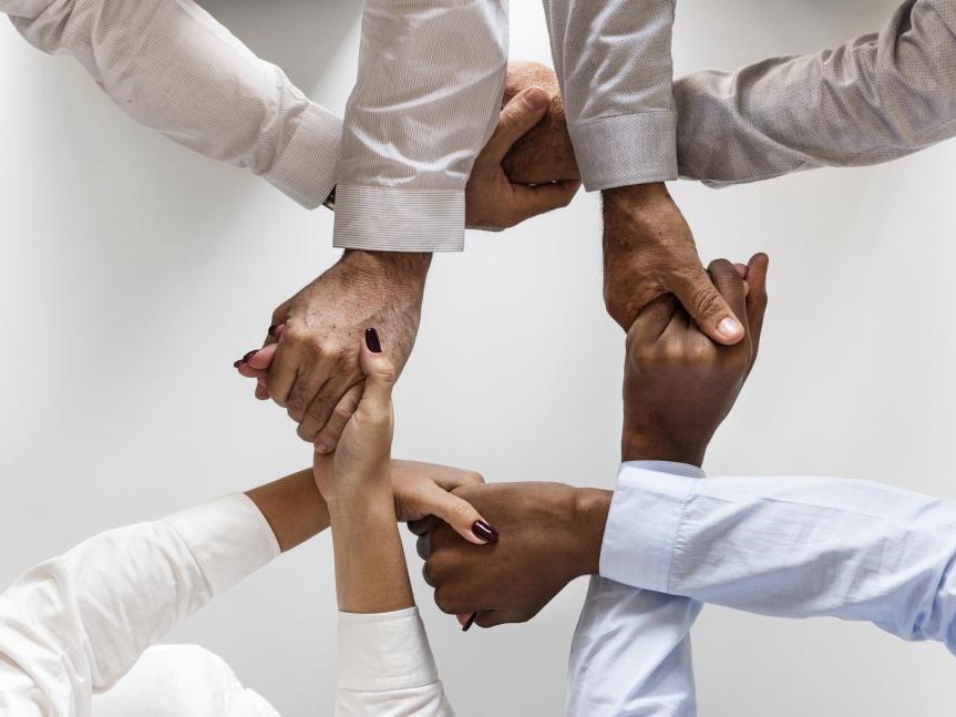 hands crossed holding each other in a group